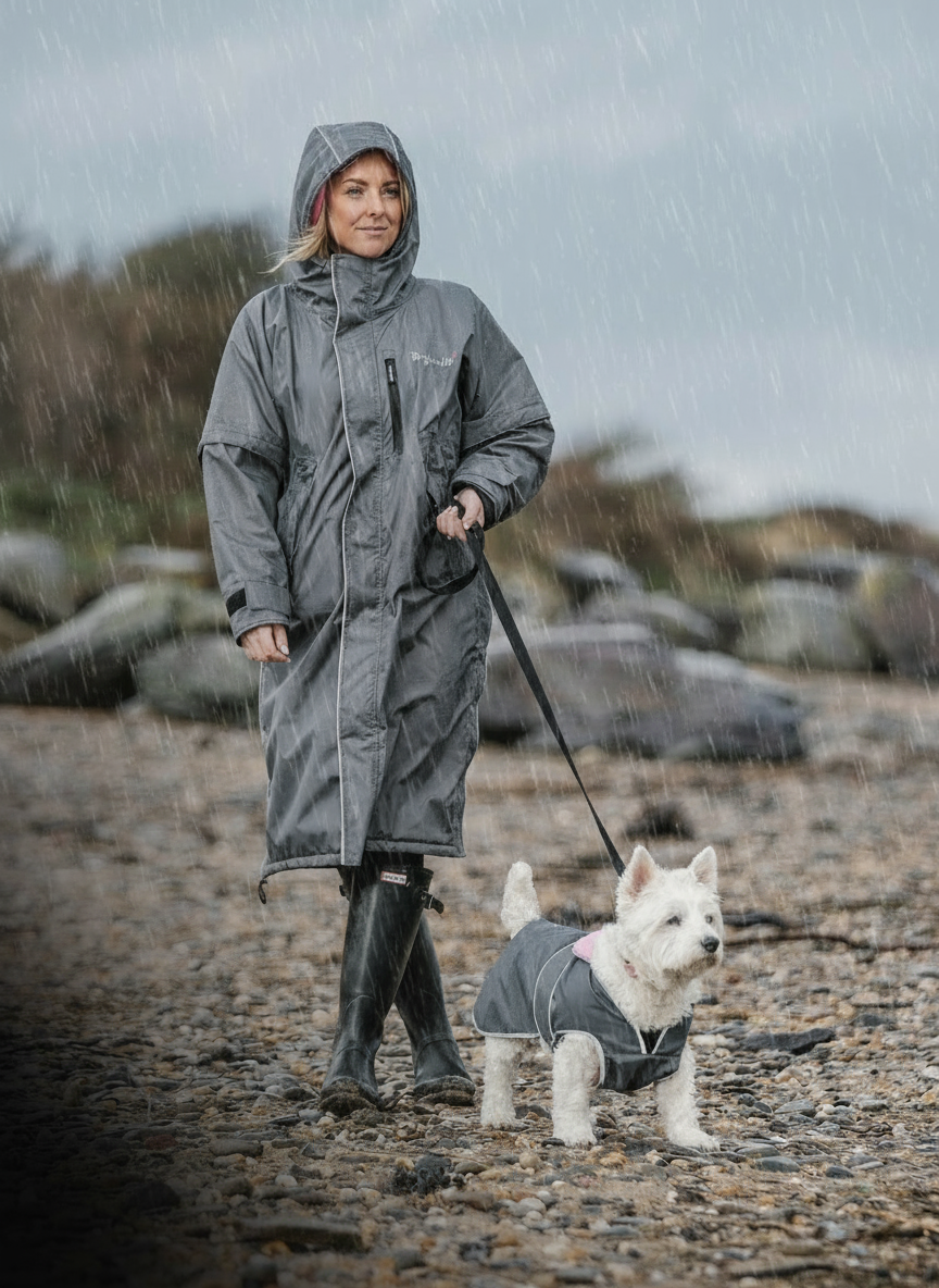 Drywalks Waterproof Dog Coat in charcoal/pink woman walking dog on beach