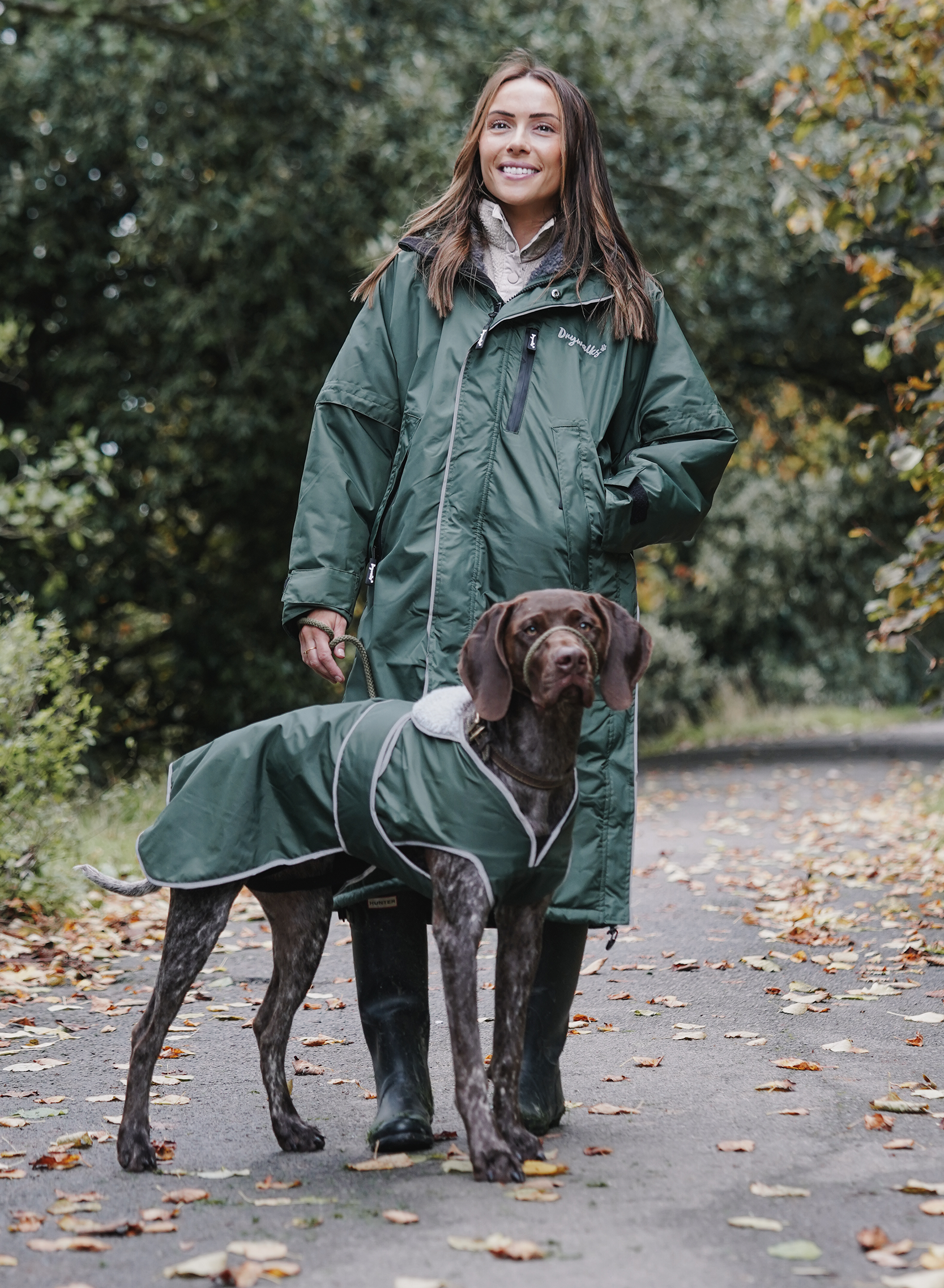Drywalks Winter Walker Waterproof Dog Walking Coat in black forest green woman on walk with dog in matching coat