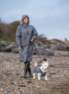 Drywalks Women's Waterproof Dog Walking Coat in charcoal/pink woman walking dog on beach