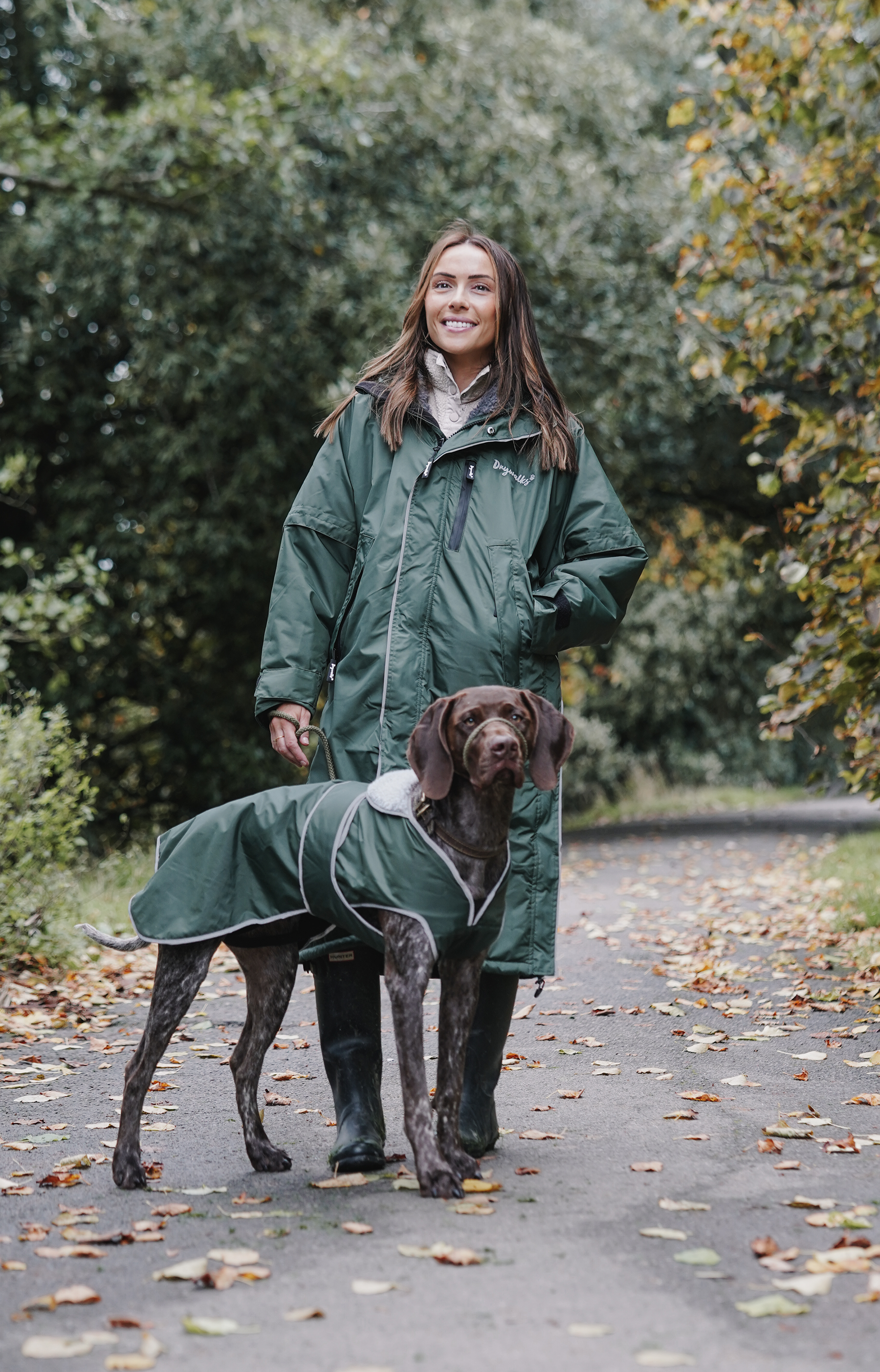 Drywalks Winter Walker Waterproof Dog Walking Coat in black forest green woman on walk with dog in matching coat